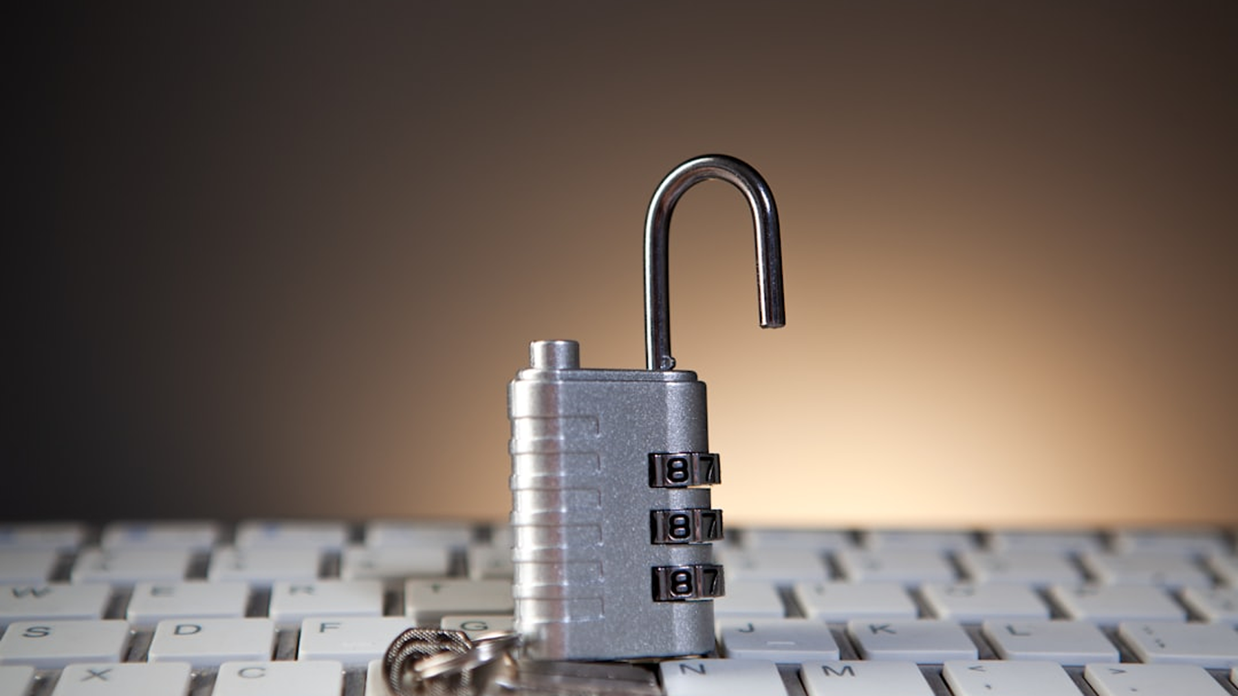 A physical padlock resting on a laptop keyboard symbolizing data privacy and secure PDF tools