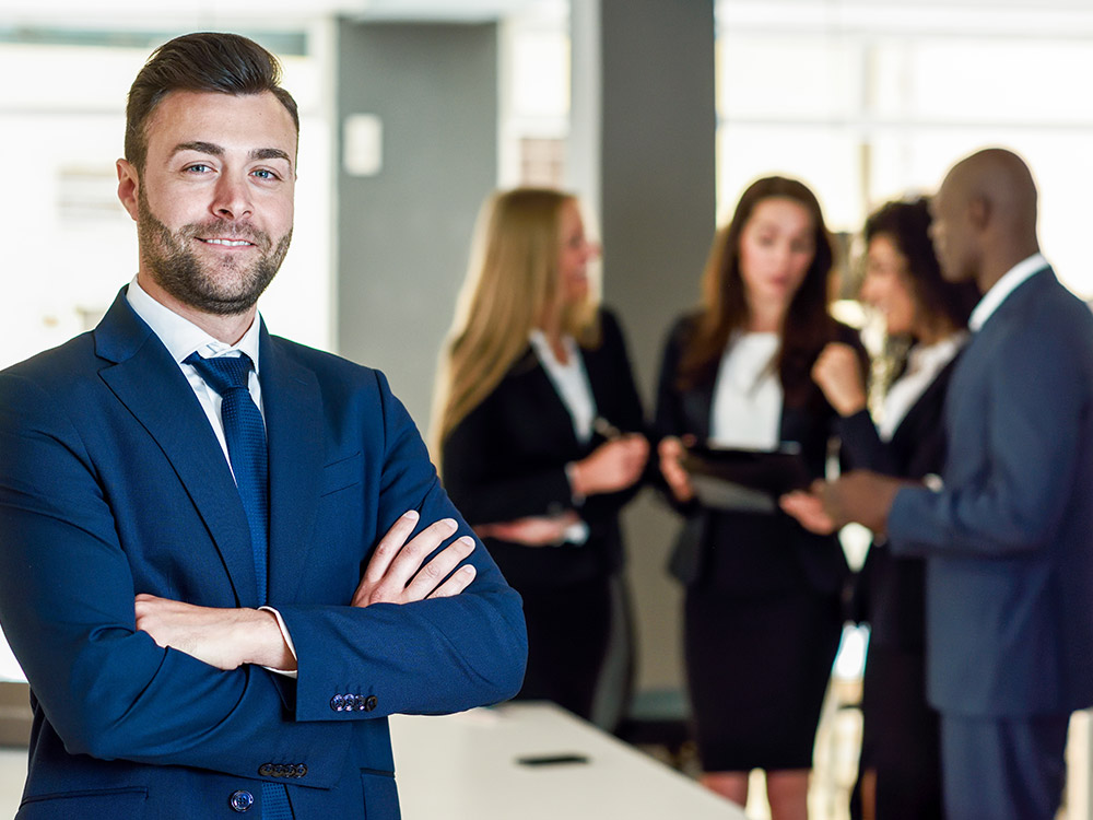 a business man using PDF online form standing with other staff at his back