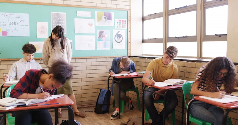 A student completing an online quiz on a tablet with a countdown timer, representing a modern digital assessment experience
